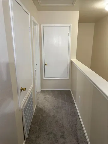 an empty room with a chandelier fan and closet