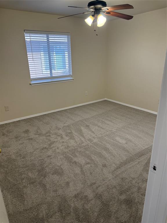 4116 Majestic Court Fort Worth, TX 76244 - Photo 34 of 37 an empty room with a chandelier fan