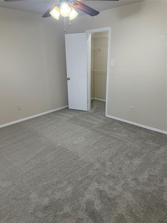 4116 Majestic Court Fort Worth, TX 76244 - Photo 35 of 37 an empty room with a chandelier fan and closet