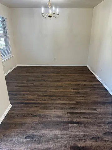 a view of room with window and wooden floor