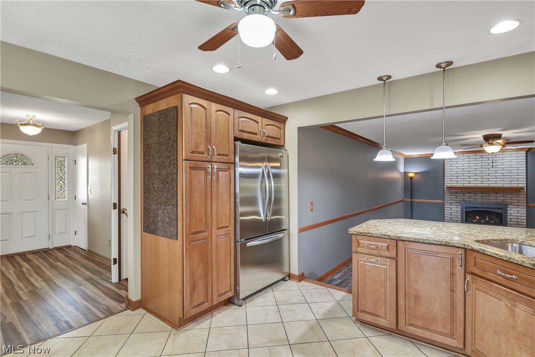 7350 Ames Road Parma, OH 44130 - Photo 11 of 50 View of the cabinetry around the stainless fridge and close up of kitchen peninsula as well as entry hallway