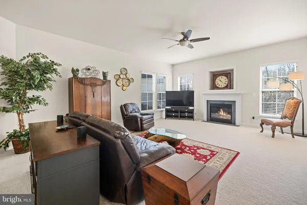 a kitchen that has a lot of white cabinets and wooden floor