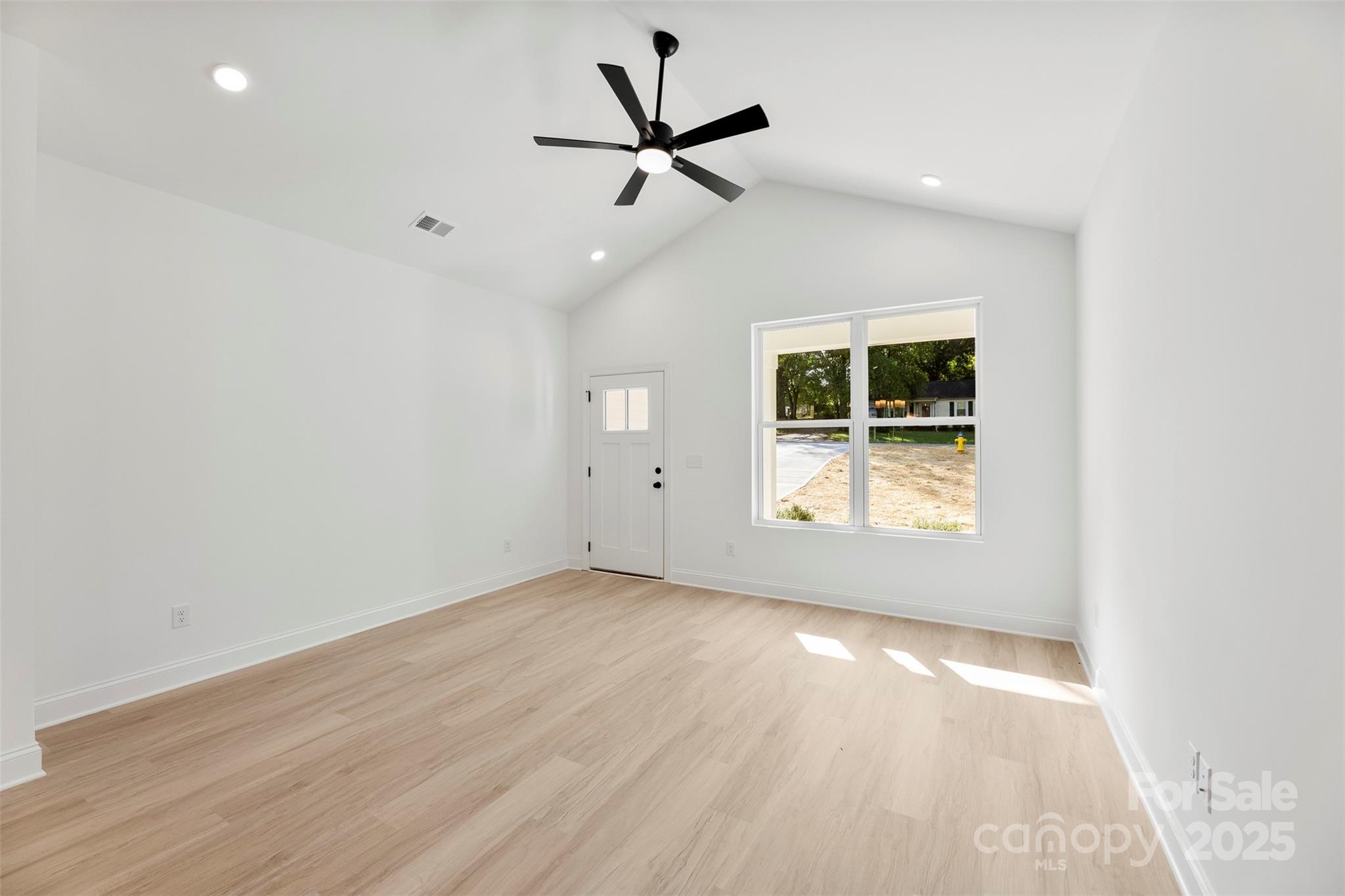 90 Sumner Avenue Northwest Concord, NC 28027 - Photo 13 of 40 an empty room with a window and a ceiling fan