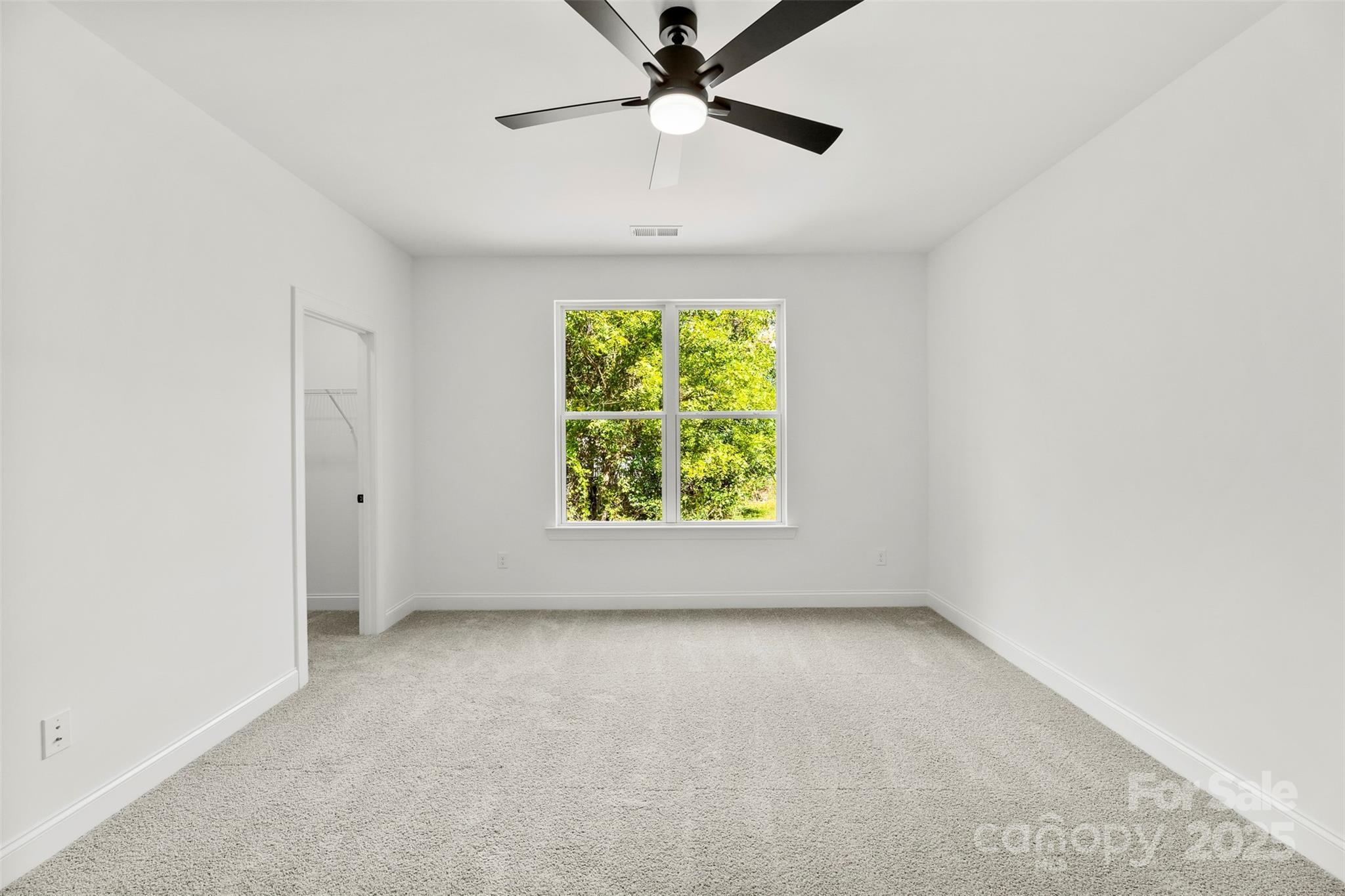 90 Sumner Avenue Northwest Concord, NC 28027 - Photo 16 of 40 an empty room with a window and a ceiling fan