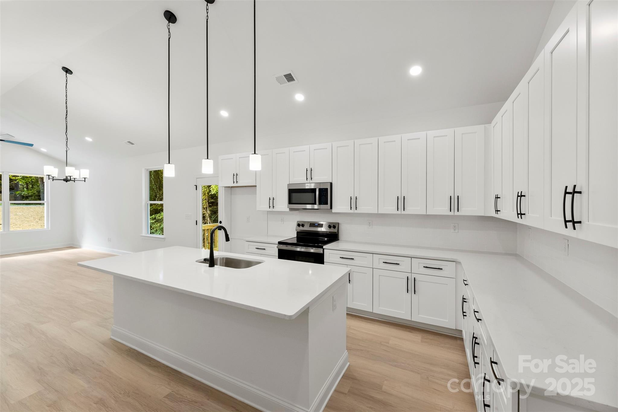 90 Sumner Avenue Northwest Concord, NC 28027 - Photo 2 of 40 a kitchen with white cabinets and stainless steel appliances