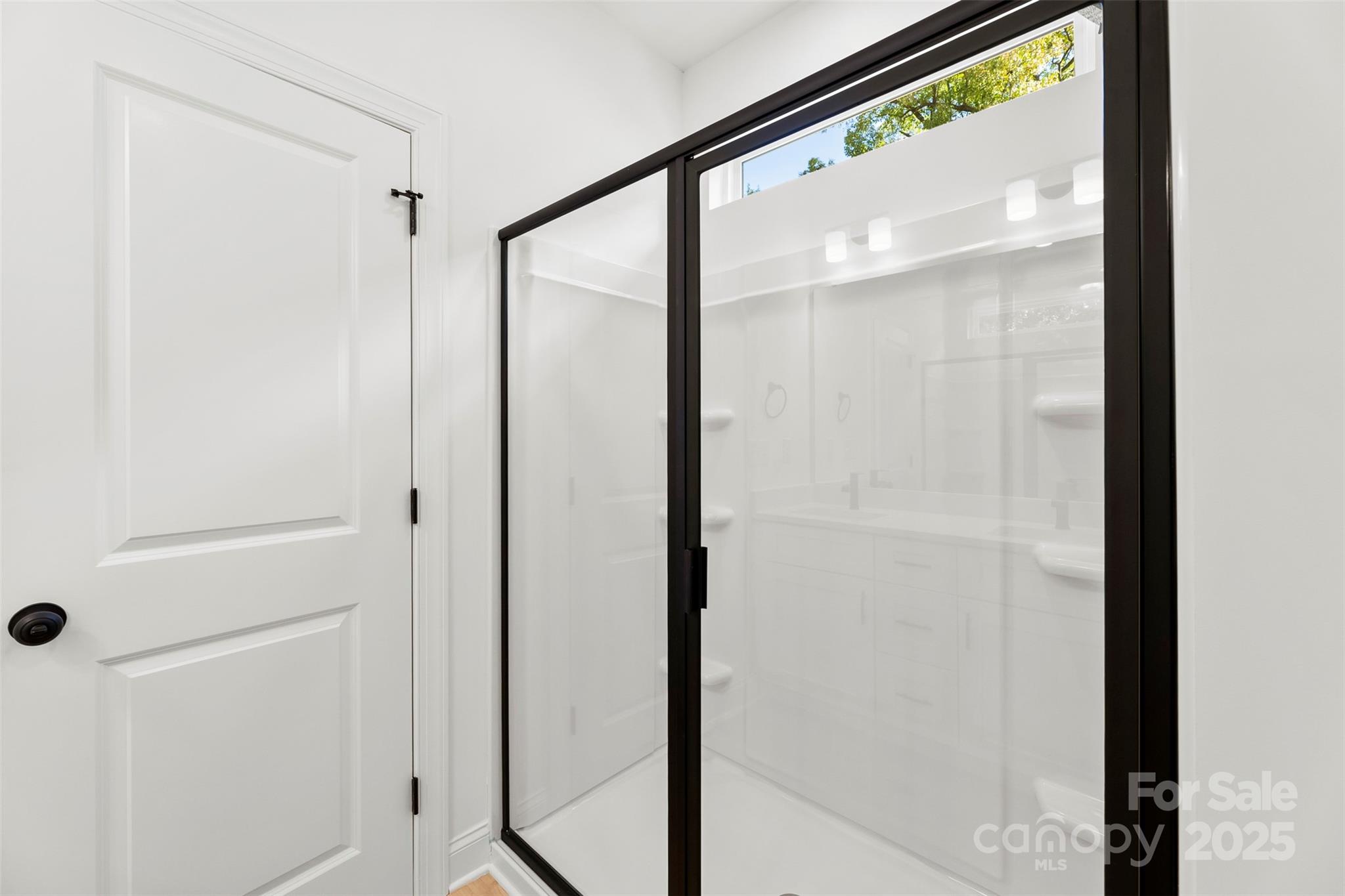90 Sumner Avenue Northwest Concord, NC 28027 - Photo 21 of 40 a bathroom with a glass shower door