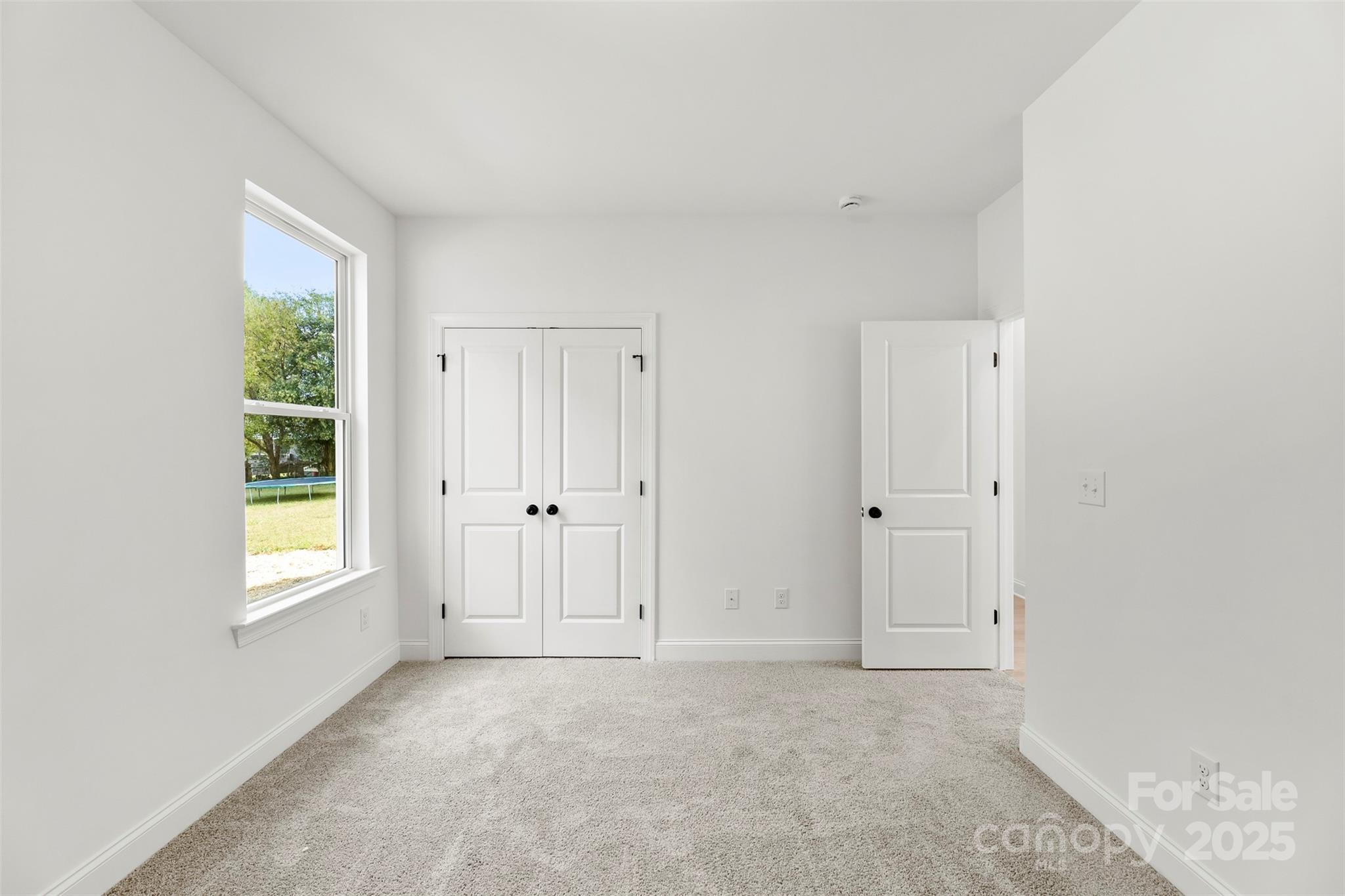 90 Sumner Avenue Northwest Concord, NC 28027 - Photo 23 of 40 an empty room with windows and closet