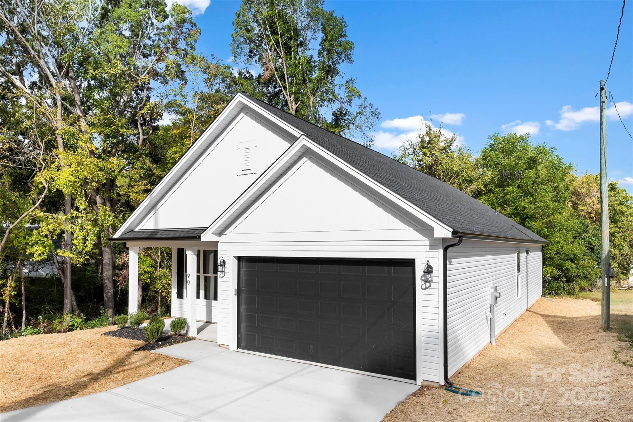 90 Sumner Avenue Northwest Concord, NC 28027 - Photo 39 of 40 a view of a house with a yard and potted plants