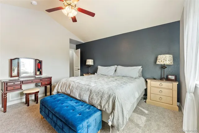 a bedroom with a bed and a desk