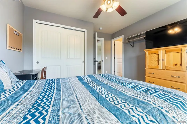 a bedroom with a large bed and a chandelier