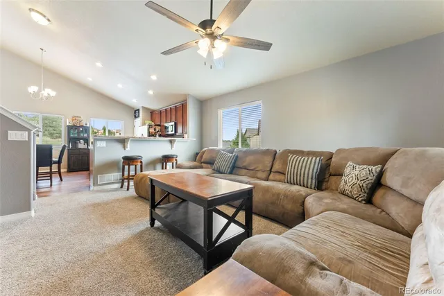 a living room kitchen with a table and chairs