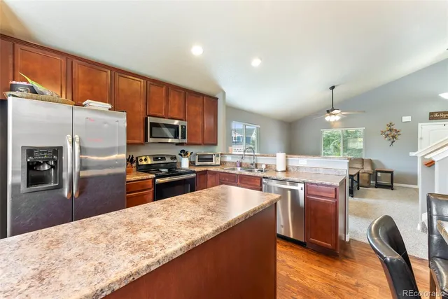 a kitchen with lots of counter top space appliances and a center island