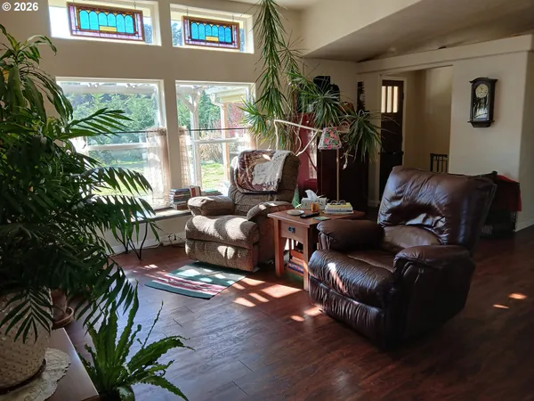 a living room with furniture and a floor to ceiling window
