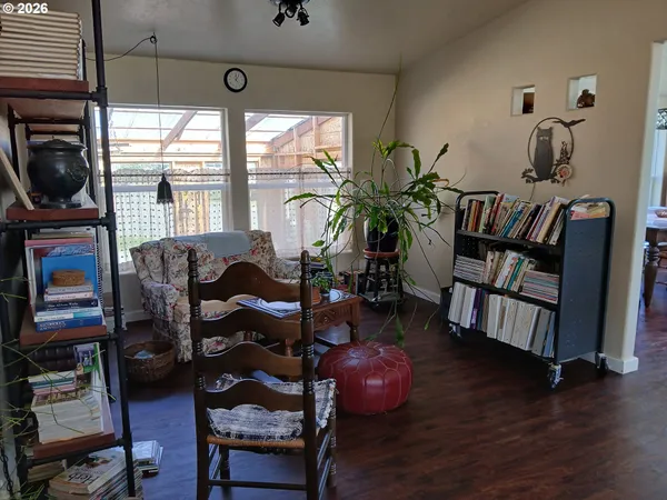 a living room with furniture and a floor to ceiling window