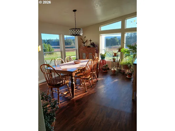 a dining room with furniture window and wooden floor