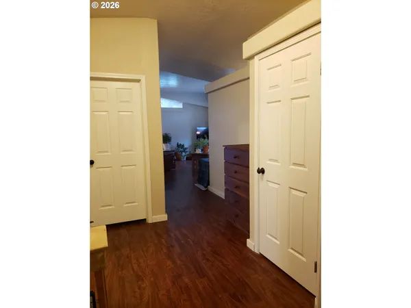 a view of a hallway with wooden floor