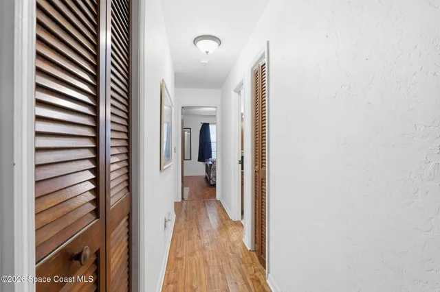 a view of a hallway with wooden floor