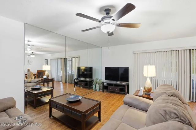 a living room with furniture a rug and a flat screen tv