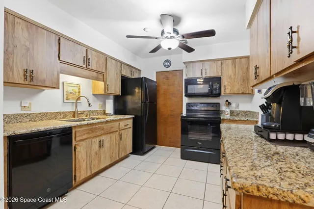 a kitchen with stainless steel appliances granite countertop a stove refrigerator and microwave
