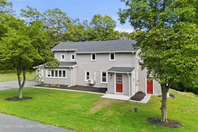a front view of house with yard and green space