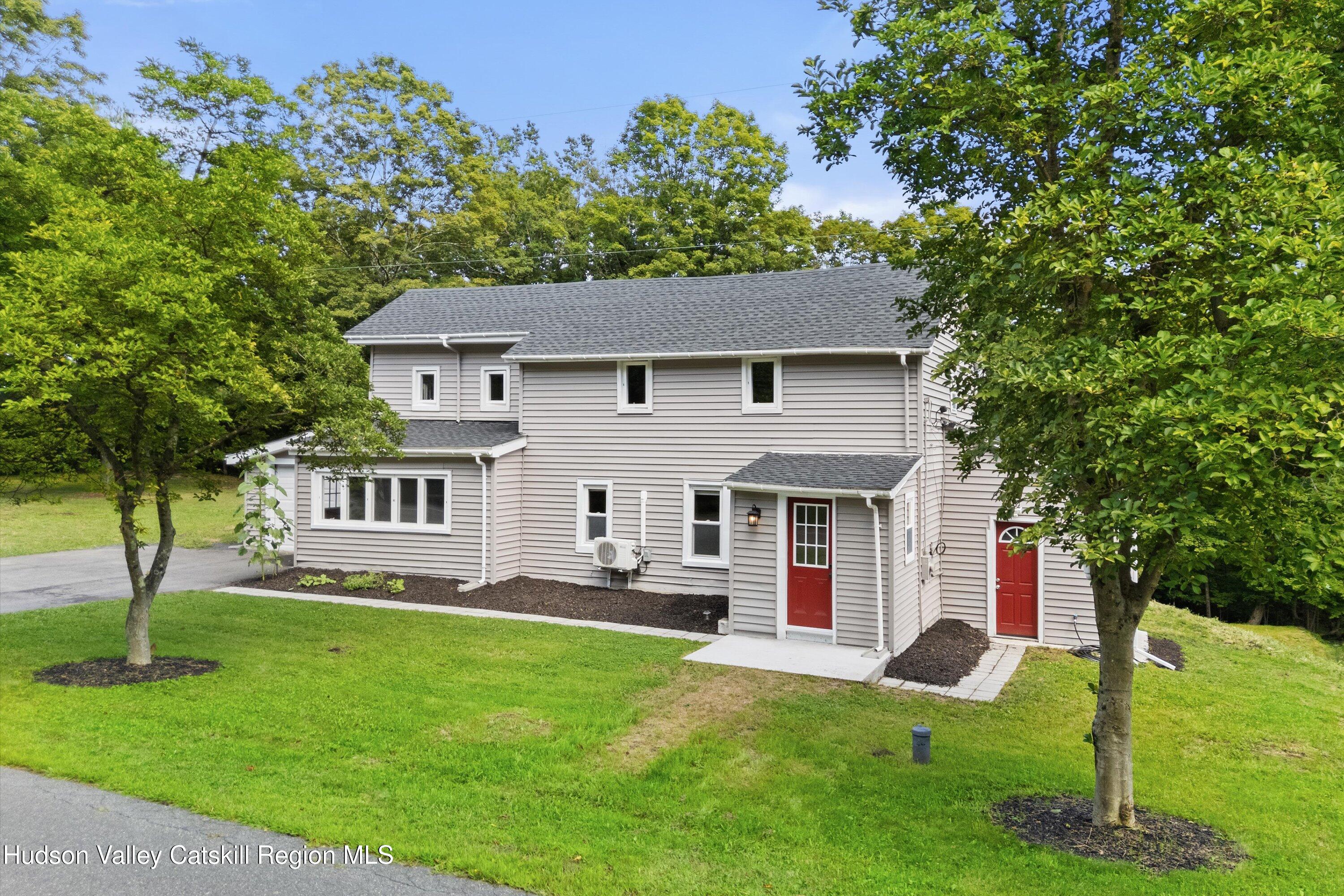 a front view of house with yard and green space