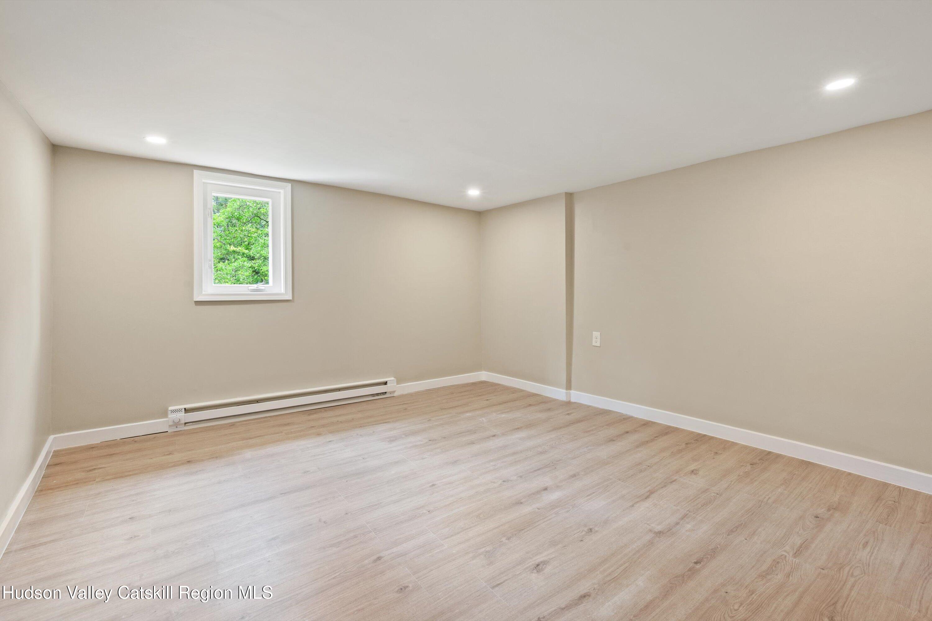 1320 Rudolph Weir Jr Road Earlton, NY 12058 - Photo 13 of 26 an empty room with wooden floor and windows