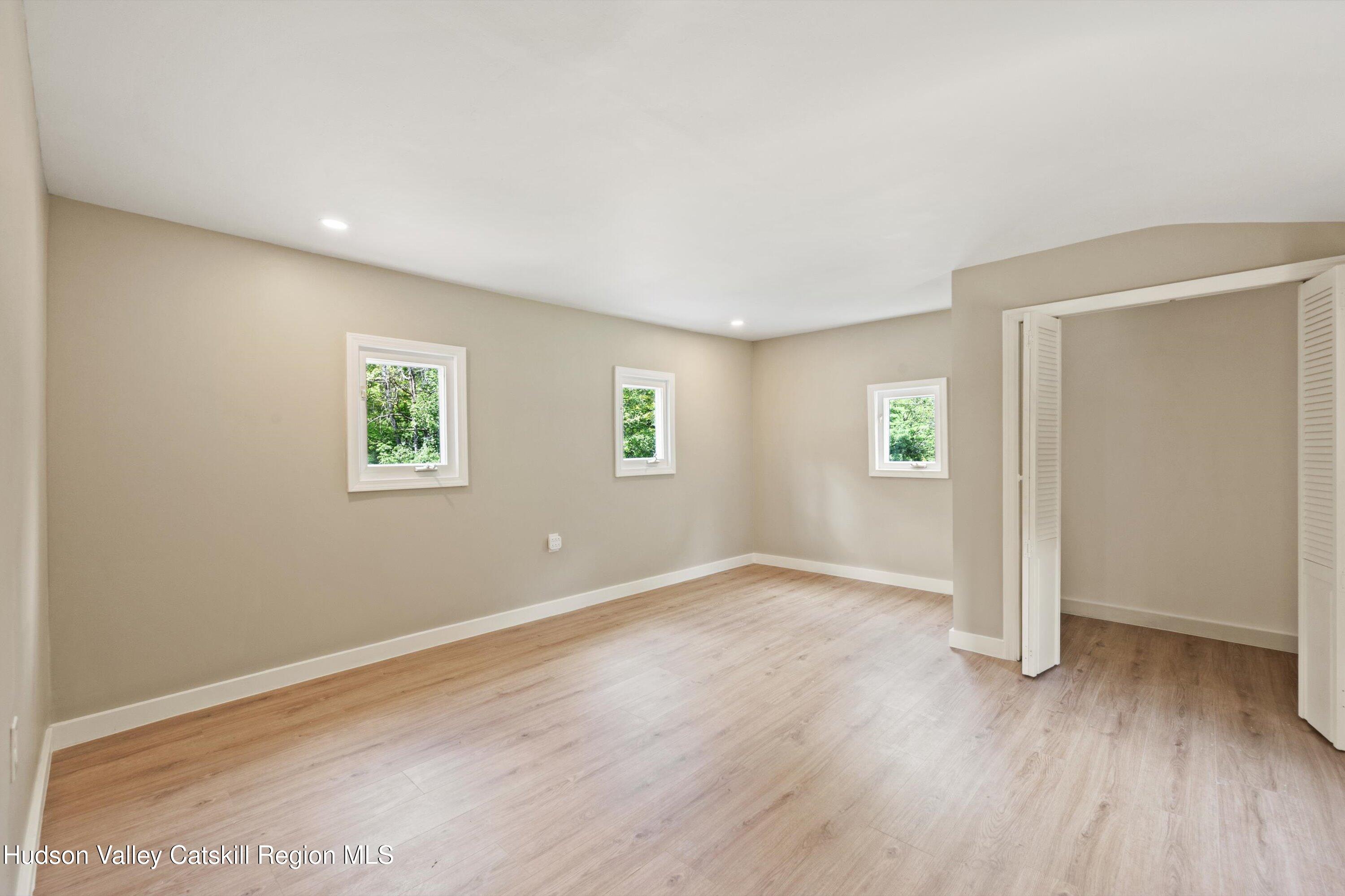 1320 Rudolph Weir Jr Road Earlton, NY 12058 - Photo 15 of 26 an empty room with wooden floor and windows