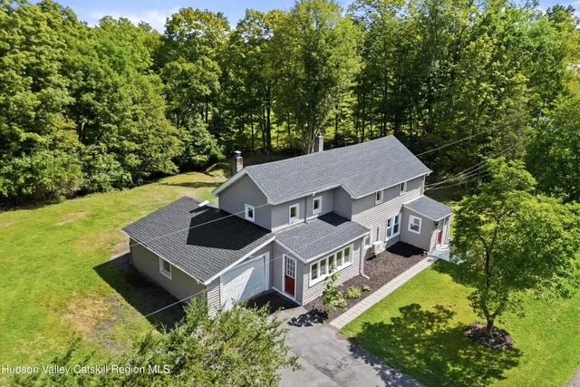 an aerial view of a house with a yard
