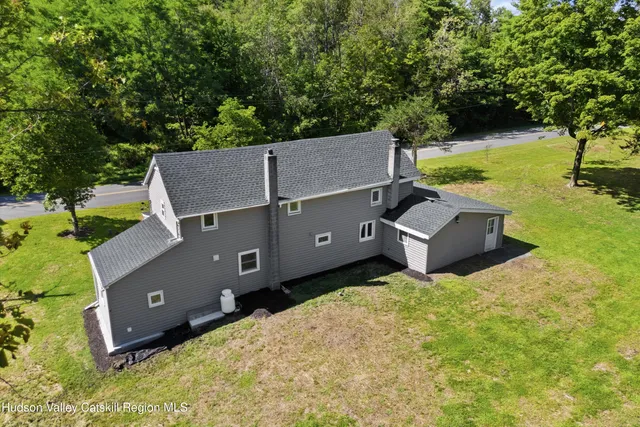 an aerial view of a house with yard