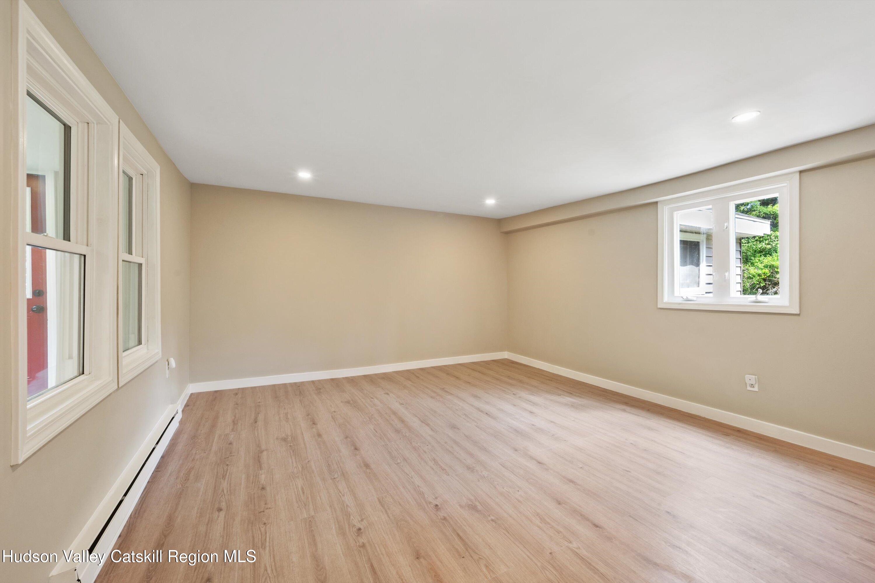 1320 Rudolph Weir Jr Road Earlton, NY 12058 - Photo 5 of 26 a view of an empty room with wooden floor and a window
