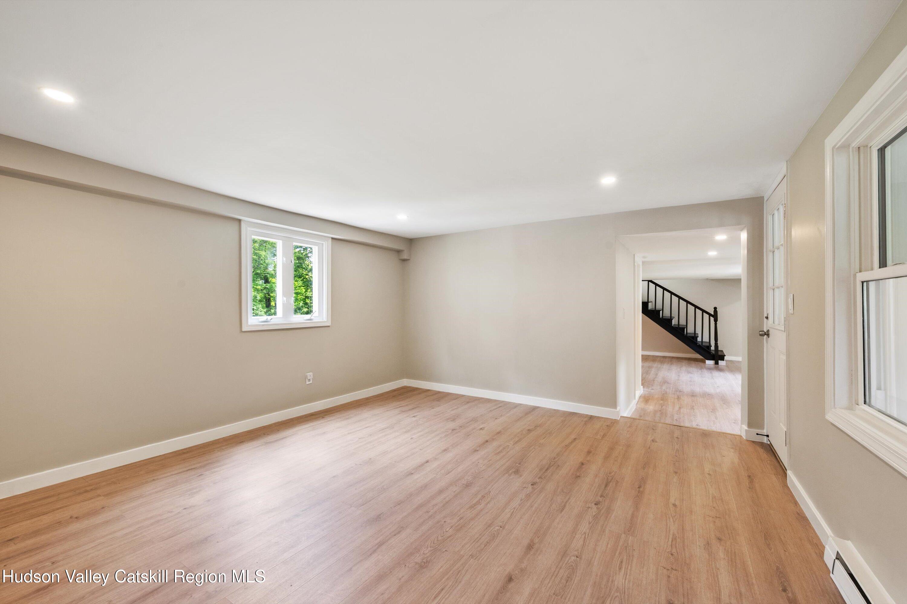 1320 Rudolph Weir Jr Road Earlton, NY 12058 - Photo 6 of 26 wooden floor in an empty room with a window