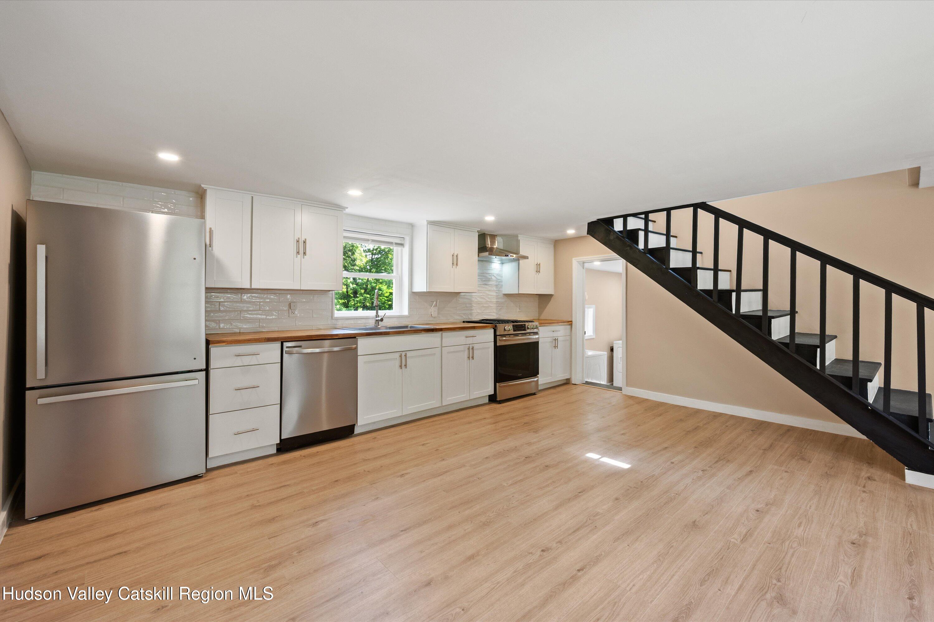1320 Rudolph Weir Jr Road Earlton, NY 12058 - Photo 7 of 26 a kitchen with white cabinets and white appliances