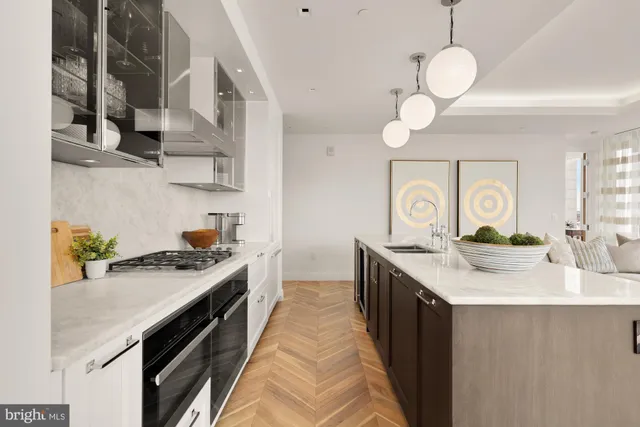 a kitchen with stainless steel appliances granite countertop a sink a stove oven and cabinets