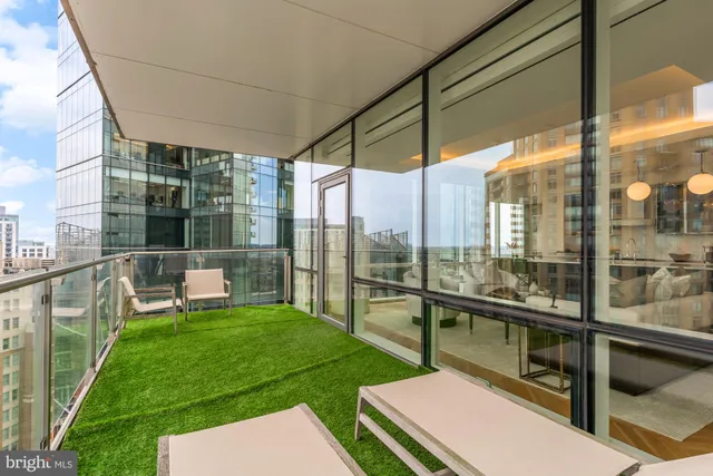 a view of a balcony with a yard