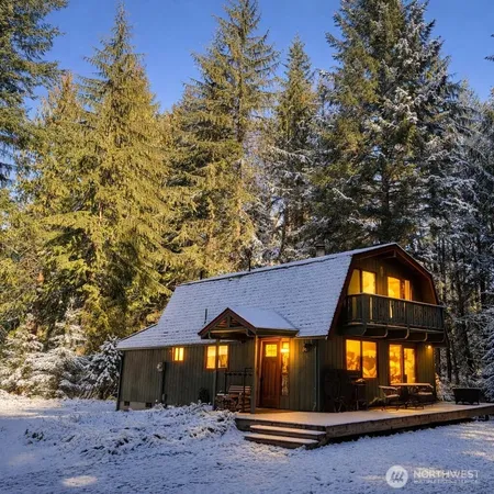 a front view of a house with yard and seating space