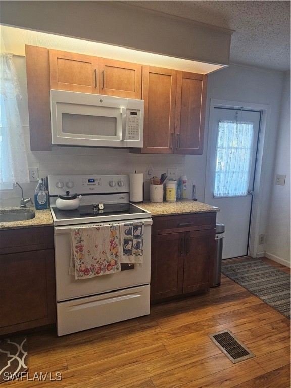 4 Elder Alva, FL 33920 - Photo 6 of 31 a kitchen with stainless steel appliances granite countertop a stove a sink and a microwave