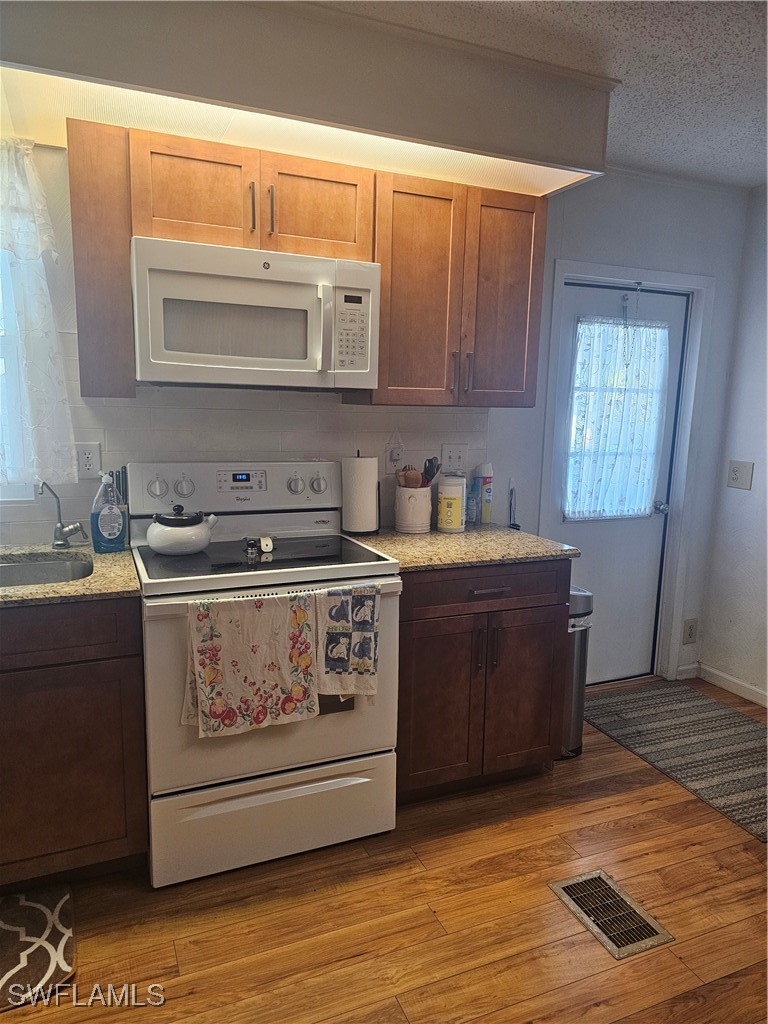 4 Elder Alva, FL 33920 - Photo 6 of 31 a kitchen with stainless steel appliances granite countertop a stove a sink and a microwave
