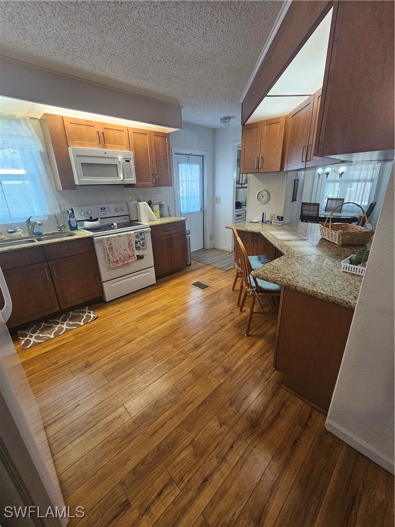 4 Elder Alva, FL 33920 - Photo 7 of 31 a kitchen with stainless steel appliances granite countertop a sink wooden cabinets and granite counter tops