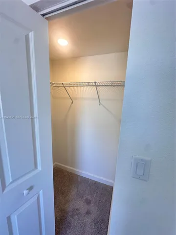 a view of a hallway with a washer and dryer