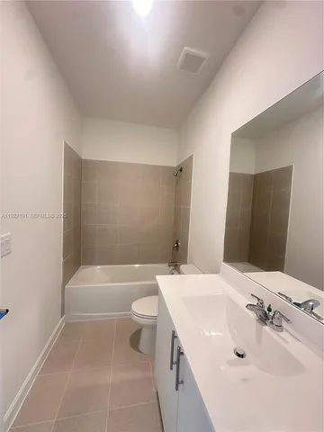 a bathroom with a sink a toilet and bathtub