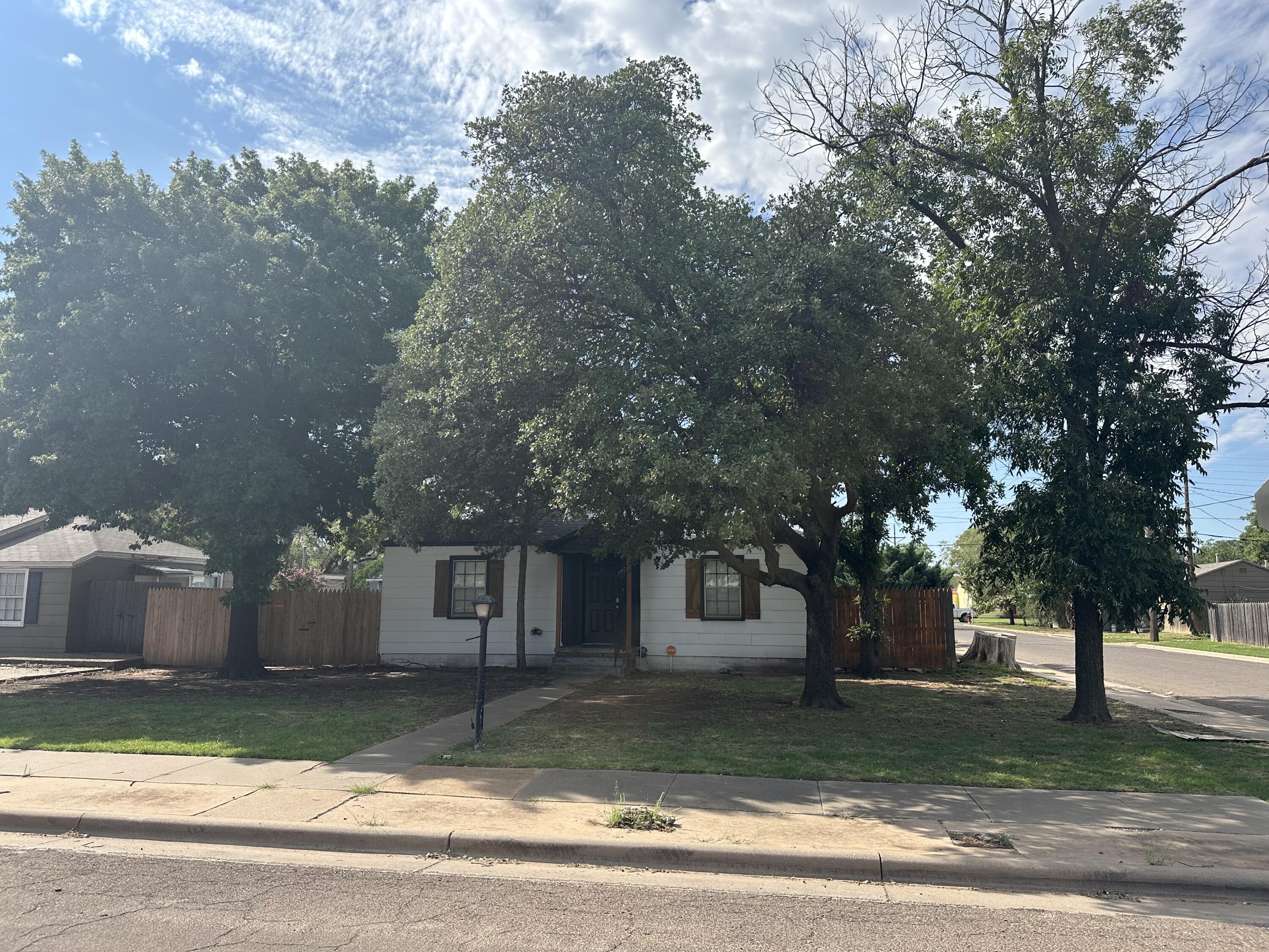 2517 28th Street Lubbock, TX 79410 - Photo 1 of 1 a view of a yard in front of a house with large trees
