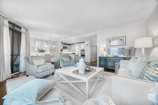 a living room with furniture and a view of kitchen