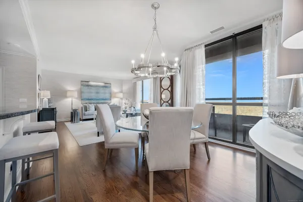 a view of a dining room with furniture window and wooden floor