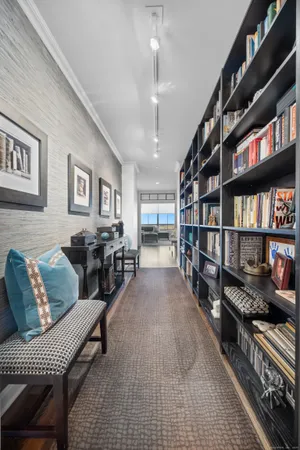 a living room with furniture a book shelf and a book shelf