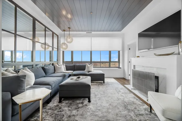 a living room with furniture and a fireplace