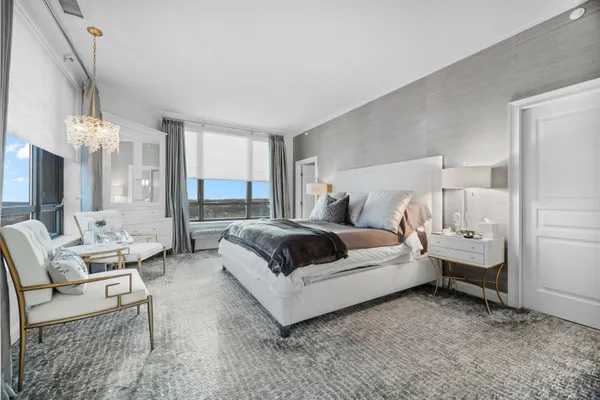 a bedroom with a bed and large mirror