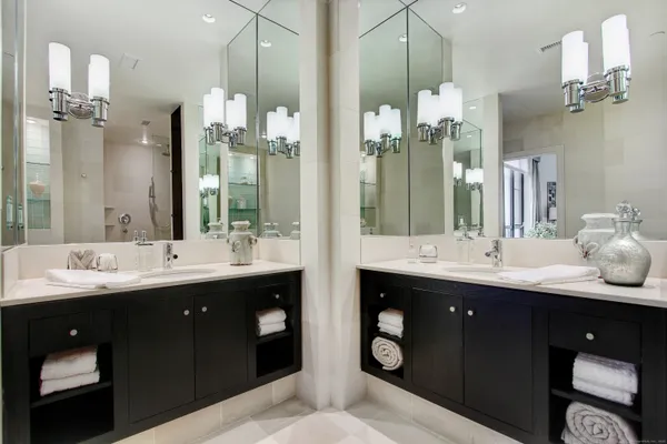 a bathroom with a double vanity sink and a mirror