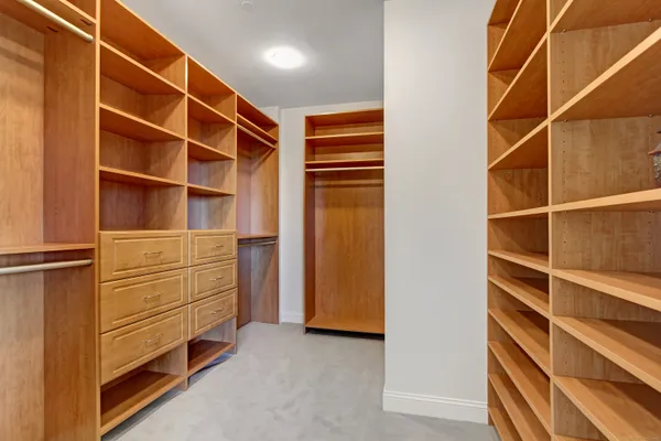 a view of walk in closet with empty racks