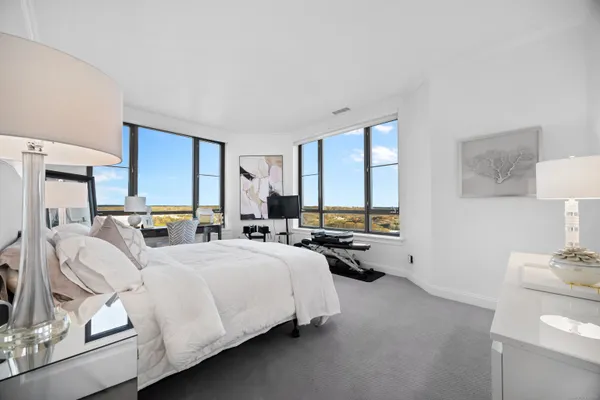 a bedroom with a bed a couch and dresser