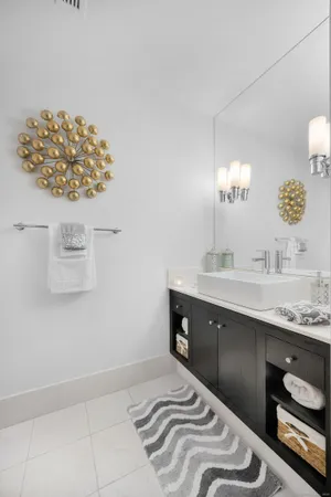 a bedroom with a sink and a mirror